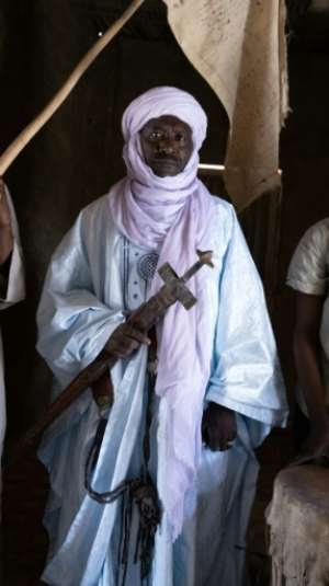 Kiari Abari Chegou, descendant of a long line of chieftains who oversee the salt trade, poses with his ceremonial sword at his palace in Bilma.  By Souleymane Ag Anara (AFP)
