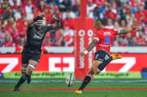 Kieran Read of the Crusaders (L) tries to block a drop goal attempt by Elton Jantjies of the Lions on August 5, 2017