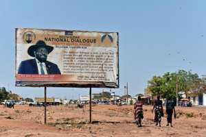 Kiir, whose image smiles from a billboard urging national dialogue, says he is ready to form a government, but the international community has warned him against doing so without Machar.  By TONY KARUMBA (AFP)