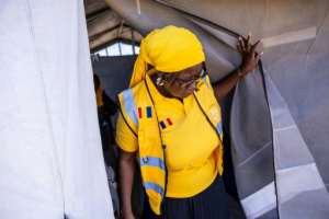 Kindi Hassan, a mental health and psychosocial support manager for the NGO International Rescue Committee, helps refugees at Goudrane camp.  By Joris Bolomey (AFP)
