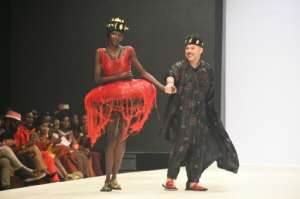 Kuame (R) with a model in one of his creations at Lagos Fashion Week, 2022. By PIUS UTOMI EKPEI (AFP)