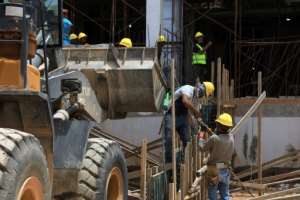 Labourers work at Al-Wahda Central Hospital, being built as part of Dernas reconstruction.  By Abdullah DOMA (AFP)