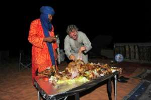 Local tour guides ready a feast in the desert near the oasis town of Djanet.  By - (AFP)