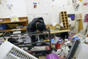 Loss: Thandi Johnson weeps inside her looted store at the Diepkloof shopping mall.  By Phill Magakoe (AFP)