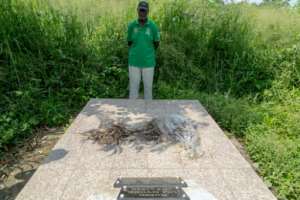 Louis Marie Mang, a UPC activist, stands before the tomb of anti-colonialist leader Ruben Um Nyobe.  By - (AFP)