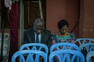 Martin Fayulu, seen praying with his wife Esther ahead of the results announcement, has rejected the declared outcome of the vote.  By Caroline Thirion (AFP)