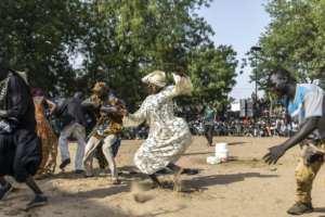 Men dressed as women dance during a ceremony for the Miss de Diobaye.  By PATRICK MEINHARDT (AFP)