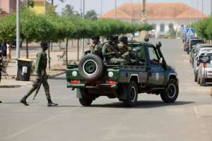 Men in military uniform took over the main road leading to the presidential palace.  By Patrick MEINHARDT (AFP)