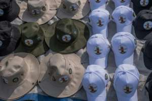 Merchants sold hats with the image of the king, who died at age 34.  By Badru KATUMBA (AFP)