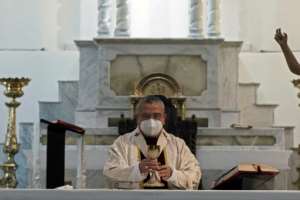 Mexican Archbishop Francisco Moreno Barron wears a face mask as he celebrates Easter Mass at the empty cathedral in Tijuana.  By Guillermo Arias (AFP)