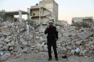Mohammed Hamroush, a member of the White Helmets in Syria uses an app on his smartphone to track bombardments.  By OMAR HAJ KADOUR (AFP)