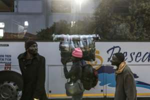 More Malawians flocked into Durbans Old Drive-In temporary camp on Friday awaiting repatriation.  By MARCO LONGARI (AFP)