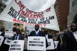 More than 100 lawyers hit the streets of Harare to demand a return of law and order.  By Jekesai NJIKIZANA (AFP)