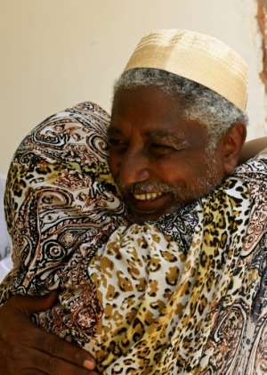 Mudawi Ibrahim Adam, a leading Sudanese activist, hugs a woman at his home in Omdourman on August 30, 2017, the day after his release from prison following a presidential pardon