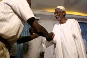 Mudawi Ibrahim Adam (R), a leading Sudanese activist, greets people at his home in Omdourman on August 30, 2017, the day after he was released from prison following a presidential pardon
