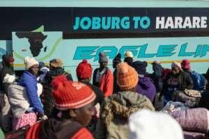 Munyai Tungamirai (red jacket and grey beanie) illegally entered South Africa in 2024.  By EMMANUEL CROSET (AFP)