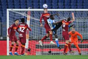 Napoli defender Kalidou Koulibaly (C) is surrounded by Roma players in a Serie A aerial duel..  By Alberto PIZZOLI (AFP)