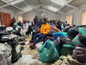 Nearly a week after the violence, around 100 foreign nationals and some South Africans are still taking shelter in a community hall.  By RODGER BOSCH (AFP)