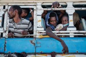 Newlyweds Luwam Hagos, right, aged 17, and Mekunnt Girmeay, second right, aged 22, in the bus to the Um Raquba refugee camp in eastern Sudan.  By Yasuyoshi CHIBA (AFP/File)