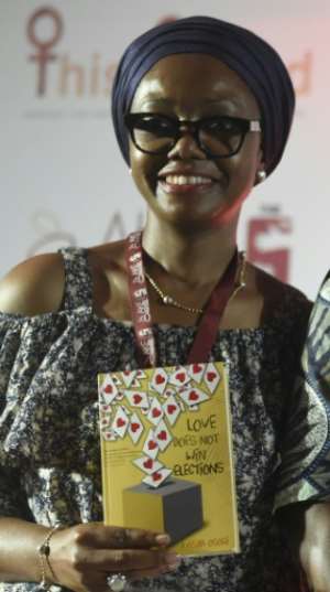 Nigerian lawyer Ayisha Osori, posing with her book Love Does Not Win Elections, blames an ossified political system for the poor female representation in national politics.  By PIUS UTOMI EKPEI (AFP)
