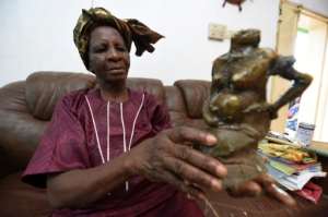 Nigerias first female bronze caster Princess Elizabeth Olowu, 77, cleans her bronze sculptures with lemon juice in her living room in Benin City