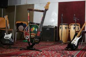 Noureddine Jaber plays a unique tambo-guitar, an instrument he fashioned from a guitar neck and his fathers vintage tamboura.  By Median Yasser (AFP)