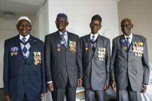 Old soldiers: Diao, far right, pictured in Paris last month with (from left) fellow veterans Gorgui MBodji, Ousmane Sagna and Oumar Dieme.  By Geoffroy Van der Hasselt (AFP)