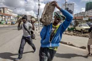 Opposition supporters carried rocks on the day of action to protest at the cost of living crisis.  By Luis Tato (AFP)