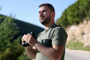 Ornithologist Xhemal Xherri observes birds in the mountains near Tepelene.  By Adnan Beci (AFP)