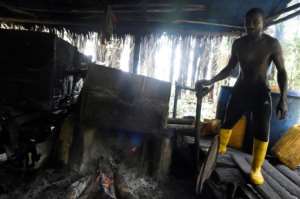 Ovwiroro and his makeshift distillery.  By Pius Utomi EKPEI (AFP)