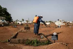 Pagmokgda keeping the weeds at bay at Ouagadougous Nagrin cemetery.  By OLYMPIA DE MAISMONT (AFP)