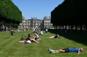 People enjoy the sun in Luxembourg Gardens in Paris after the French capital reopened parks for the first in months.  By BERTRAND GUAY (AFP)