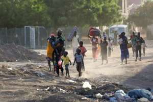 People flee their neighbourhoods amid fighting between the army and paramilitaries in Khartoum.  By - (AFP)