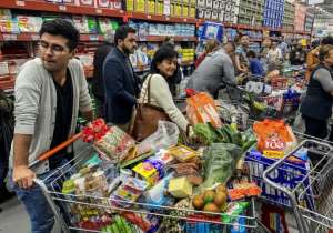 People rush to buy food and supplies in a supermarket before quarantine hits in Bogota, Colombia.  By Daniel MUNOZ (AFP)