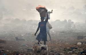 People scavenge at a Freetown rubbish dump.  By ISSOUF SANOGO (AFP/File)