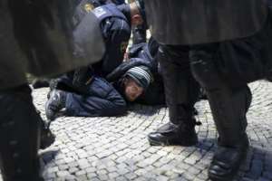 Police officers hold down a protester during a rally against coronavirus restrictions in Ljubljana, Slovenia.  By Jure Makovec (AFP)