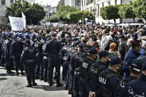 Policemen stop Algerian protesters from advancing down a street during an anti-government protest in Algiers on March 9, 2021.  By RYAD KRAMDI (AFP)