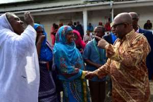 President Azali Assoumani shakes hands as he arrives to vote during a referendum last July which supposedly gave him 93 percent public backing for changing the constitution to allow Comoros presidents to hold two consecutive terms.  By TONY KARUMBA (AFP/File)