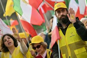 Protesters brandish stickers reading No Shah, no Mullah during a rally in Paris.  By LOU BENOIST (AFP)