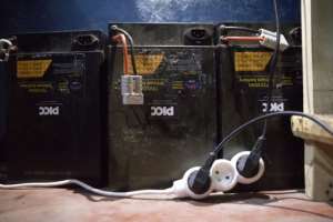 Rechargeable batteries used by electric motorcycle drivers are charged in a store in Cotonou.  By Yanick Folly (AFP)
