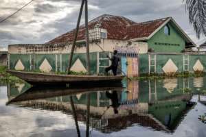 Residents have become accustomed to travelling by boat in Gatumba.  By Luis TATO (AFP)
