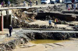Residents of the Tunisian coastal region of Nabeul gather at the site of collapsed bridge following deadly flash flooding in the town of Bir Challouf.  By FETHI BELAID (AFP)