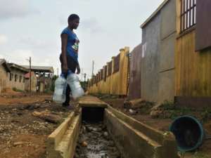 Residents struggle with daily chores as floods become more frequent in the port city of Douala.  By Adrien MAROTTE (AFP)