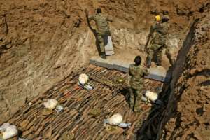 Rifles taken from the public in Sudan are placed in a pit before they are blown up -- there some 2.76 million illegally-held weapons in Sudan in 2017, or 6.6 guns for every 100 people, experts estimate.  By ASHRAF SHAZLY (AFP)