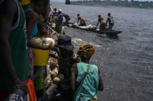 River vendors moor on the whaleboat to sell their goods.  By Arsene Mpiana (AFP)