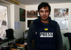 Sardar Ahmad, a Kabul-based staff reporter at the Agence France-Presse poses for a photo hours before he, his wife and two of his three children were gunned down at the Serena hotel.  By WAKIL KOHSAR (AFP/File)