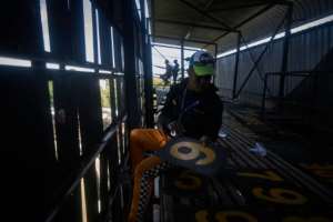 Scoreboard operator Zenzele Ndebele swaps numbers from within the manual scoreboard at Queens Sports Club in Bulawayo.  By Zinyange Auntony (AFP)