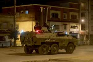 Security forces have deployed to stem the protests; here members of the National Guard patrol Ettadhamen on January 17.  By FETHI BELAID (AFP)