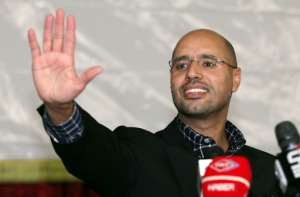 Seif al-Islam Kadhafi, son of slain Libyan dictator Moamer Kadhafi, waves during a meeting with young people in the capital Tripoli in this March 10, 2011 picture.  By Mahmud TURKIA, - (AFP/File)