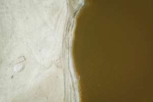 Separated from the Atlantic by a narrow dune, the shallow lake is densely laden with salt.  By PATRICK MEINHARDT (AFP)